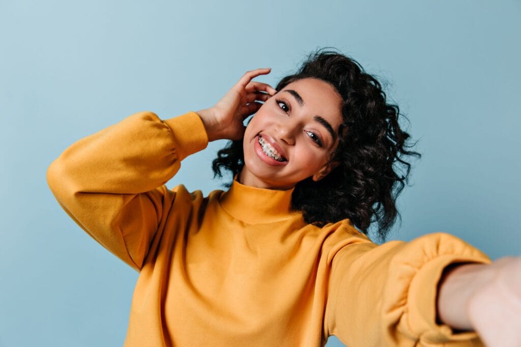 A woman shows off the gorgeous smile crafted by her braces.