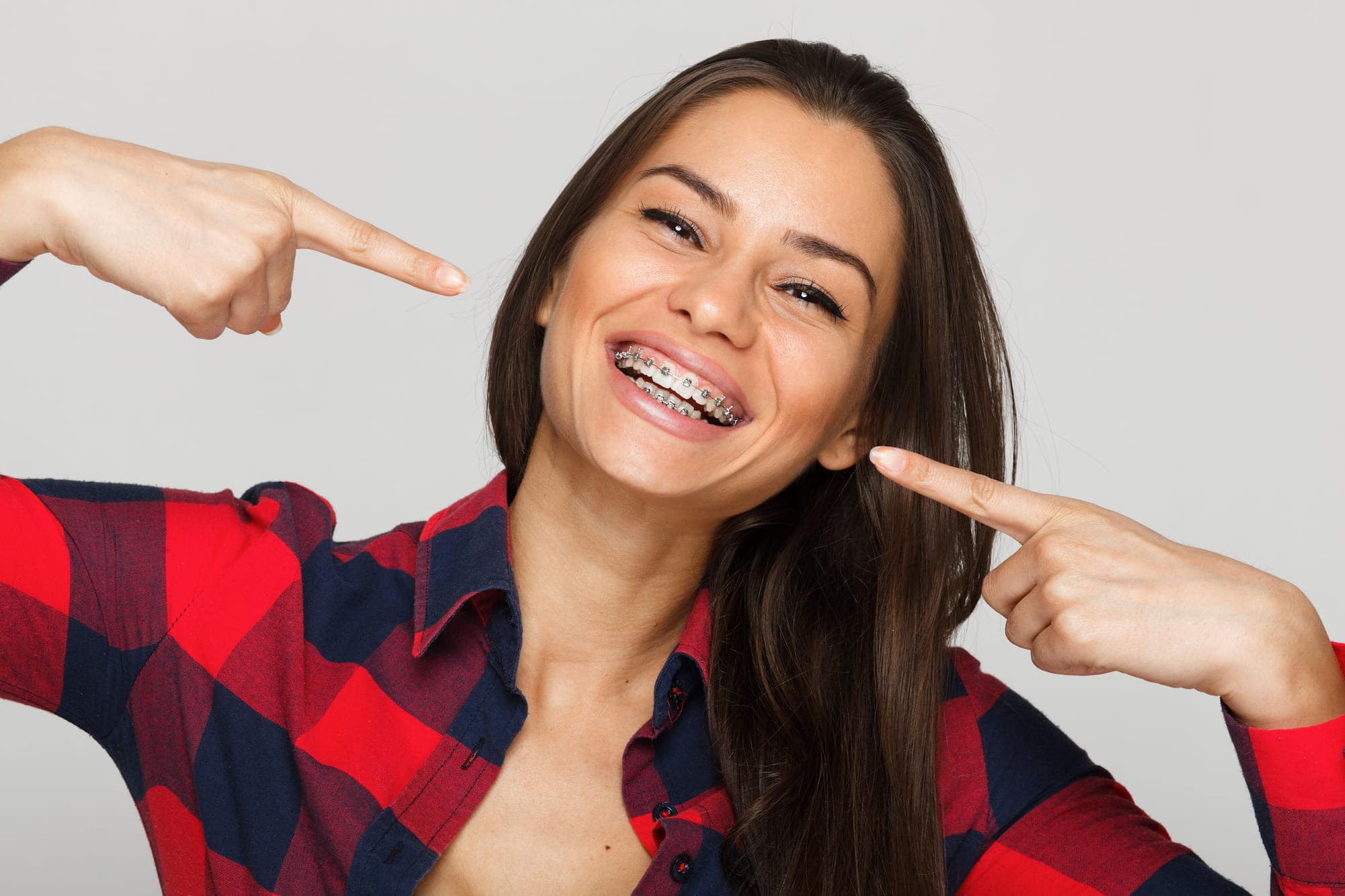 A woman smiles showing off her braces